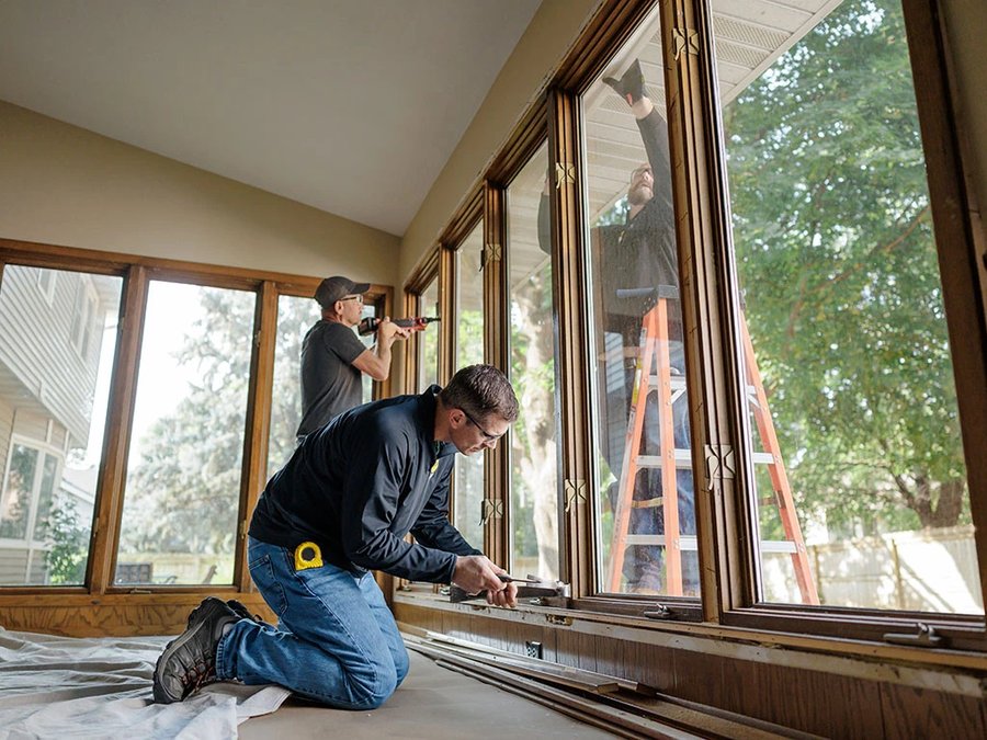 Installer fitting a new energy-efficient window